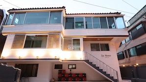 A multi-story building with a staircase leading to the entrance, labeled "Liz House." - Liz's House - Hostel (Seoul)