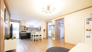 A modern apartment with a kitchen, dining area, and a living room. - Liz's House - Hostel (Seoul)
