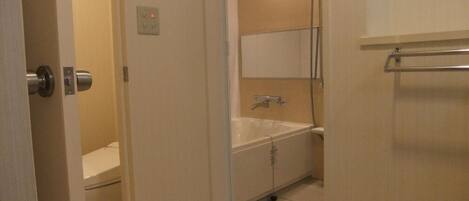 A bathroom with a bathtub, a shower, and a toilet.