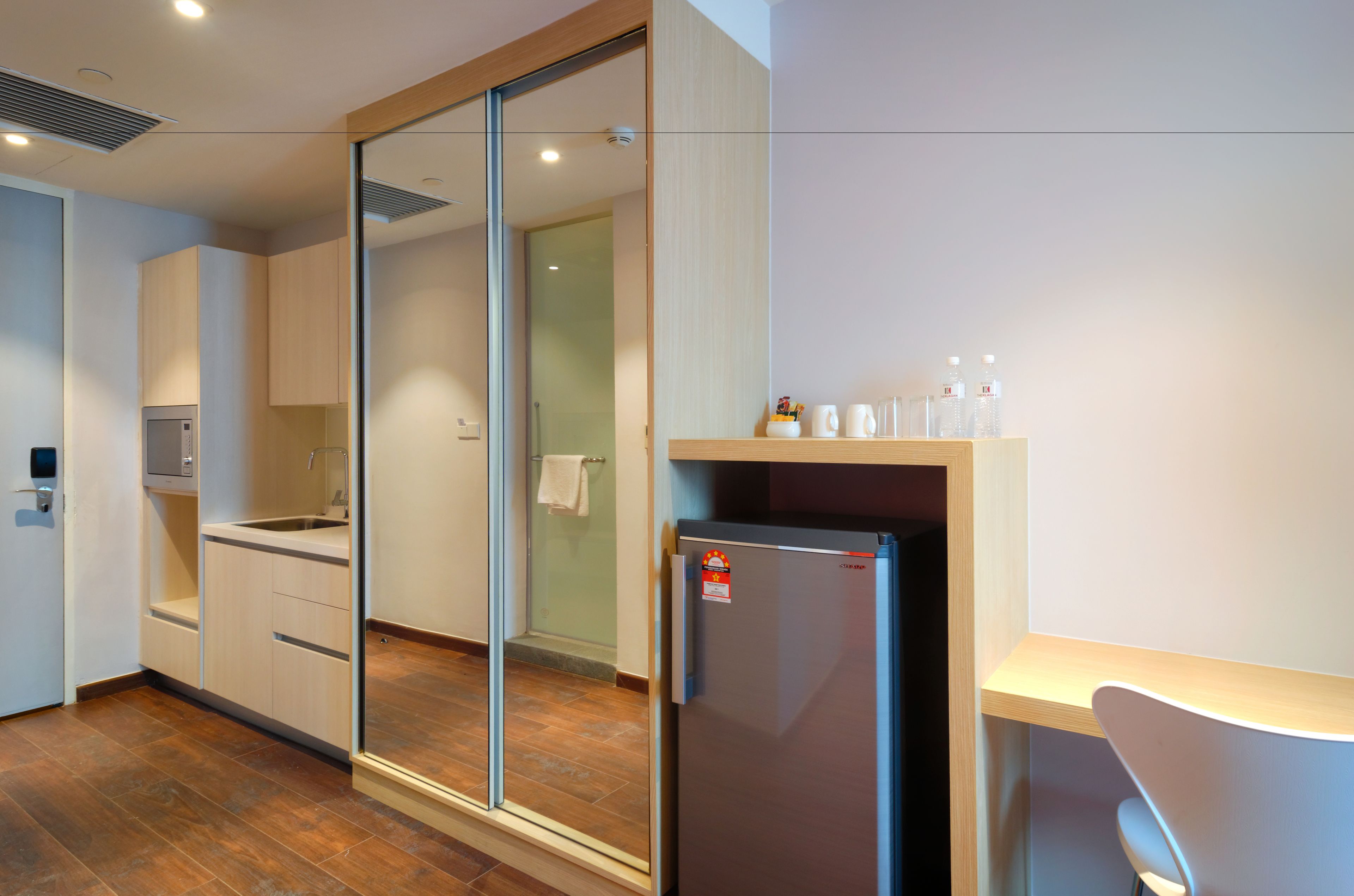 A modern kitchen with a refrigerator, sink, and cabinets.