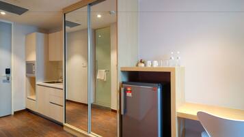 A modern kitchen with a refrigerator, sink, and cabinets.