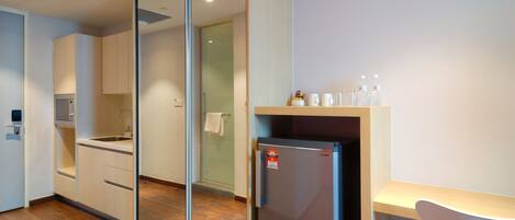 A modern kitchen with a refrigerator, sink, and cabinets.