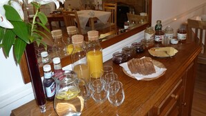 A dining table with various food items, drinks, and condiments. - Failte Bed and Breakfast (Oban)