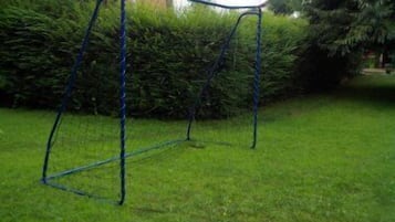 Relax in a serene outdoor space with a charming metal swing set amidst lush greenery.