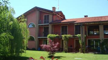 Stunning two-story building with a central entrance and beautifully manicured grounds.