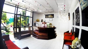 A reception area with a desk, chairs, and a large window. - Colombo Residency (Colombo)