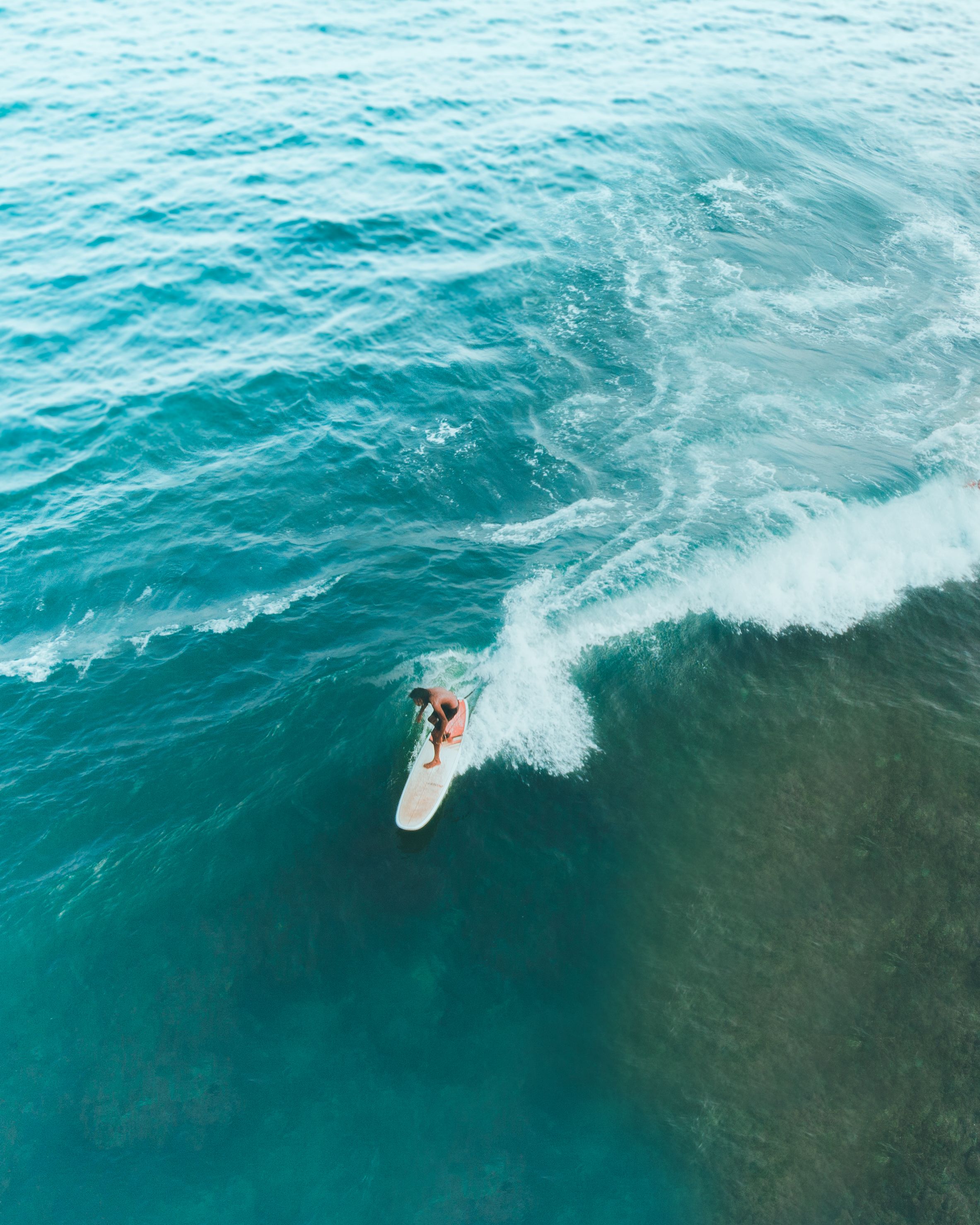 A person surfing on a wave in the ocean.