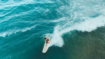 A person surfing on a wave in the ocean.