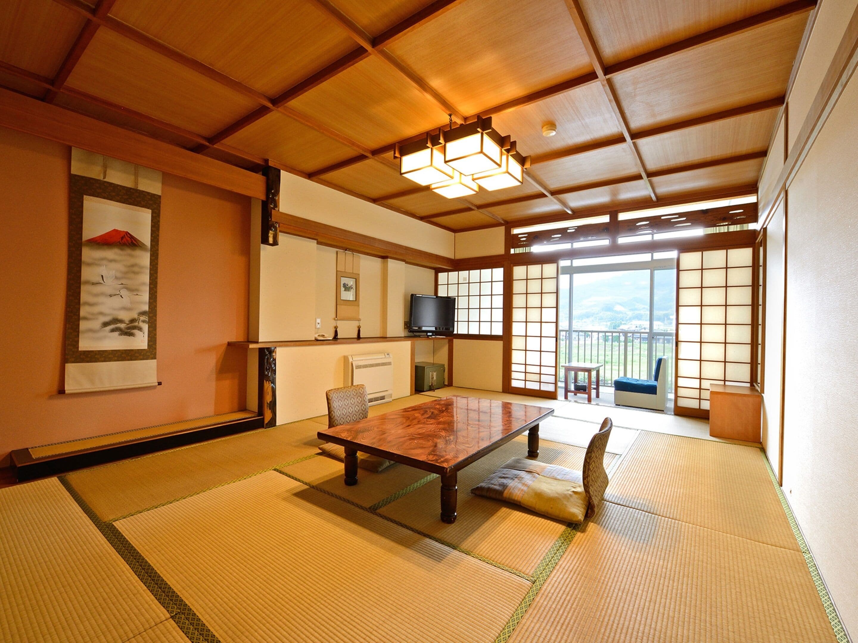 A traditional Japanese room with tatami flooring, a low table, and shoji screens.
