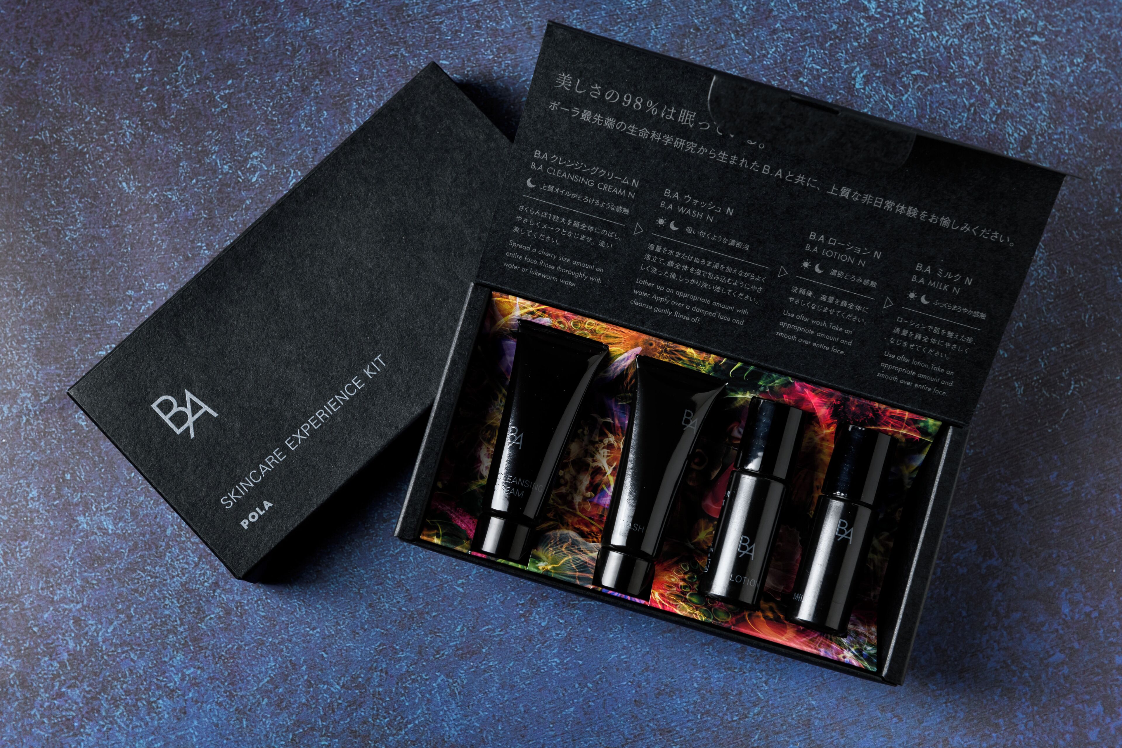 A skincare product box with four items and a booklet.