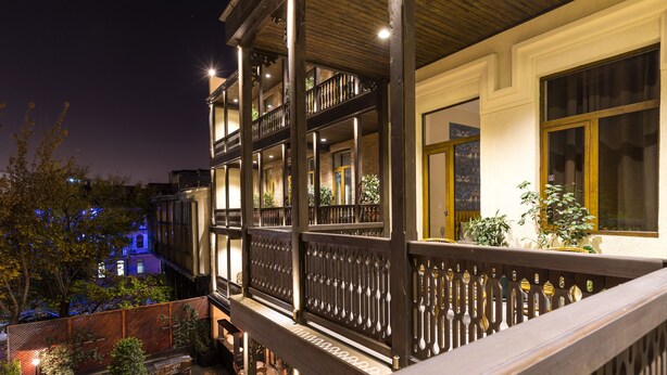 A multi-story building with balconies, outdoor seating, and potted plants. - Museum Hotel Orbeliani (Tbilisi)