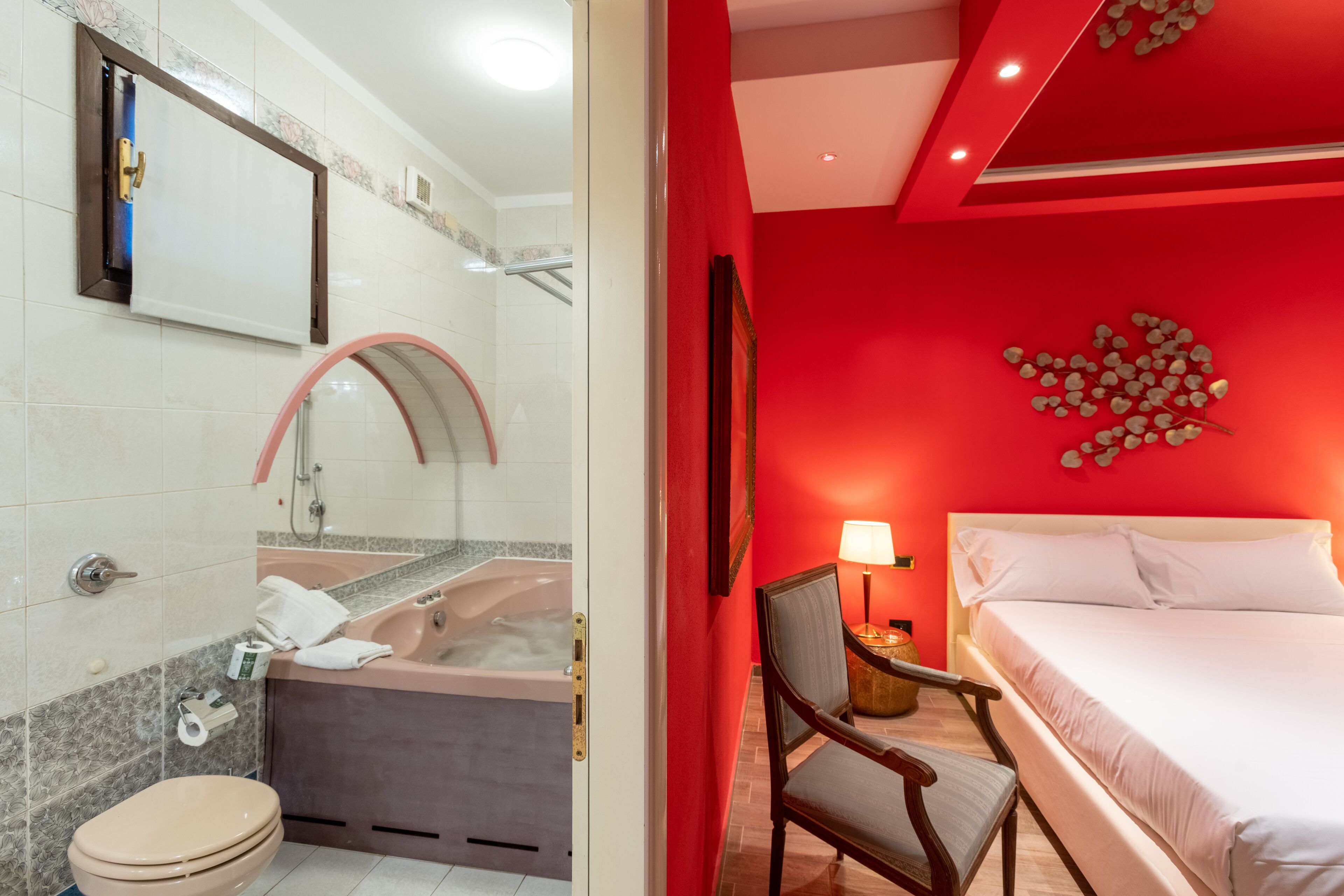 A modern bathroom with a bathtub, toilet, and shower.