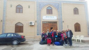 A group of people standing in front of a building with a sign that reads "HOTEL". - Islambek Hotel & Travel (Khiva)