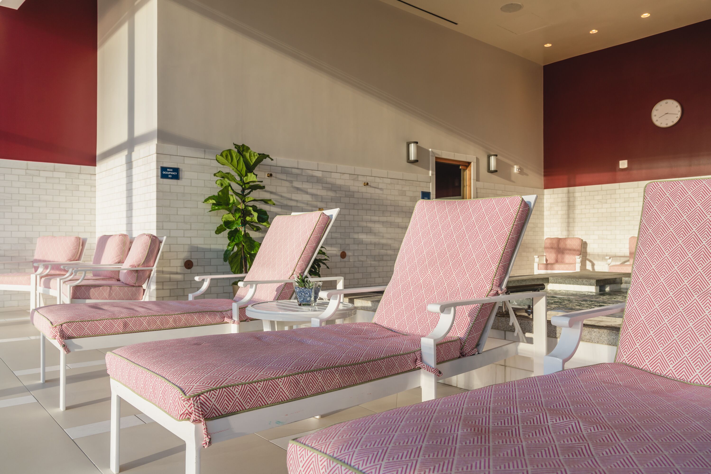 A spa area with lounge chairs and a small pool.