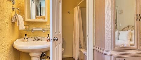 A bathroom with a sink, mirror, and vanity cabinet.
