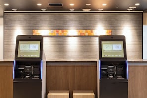 Two self-service kiosks with screens displaying instructions in English. - KEIKYU EX HOTEL Takanawa (Tokyo)