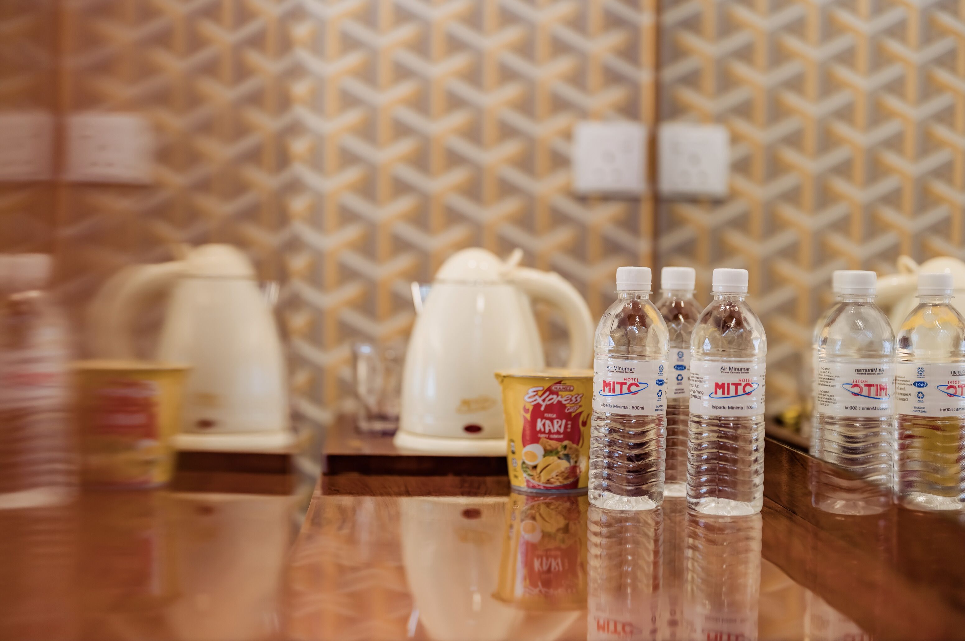A kitchen counter with water bottles, a coffee maker, and a canister.