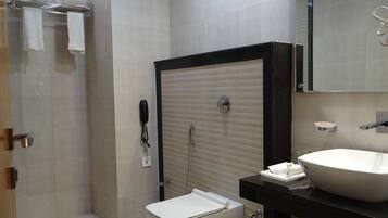 A modern bathroom with a toilet, sink, and shower.