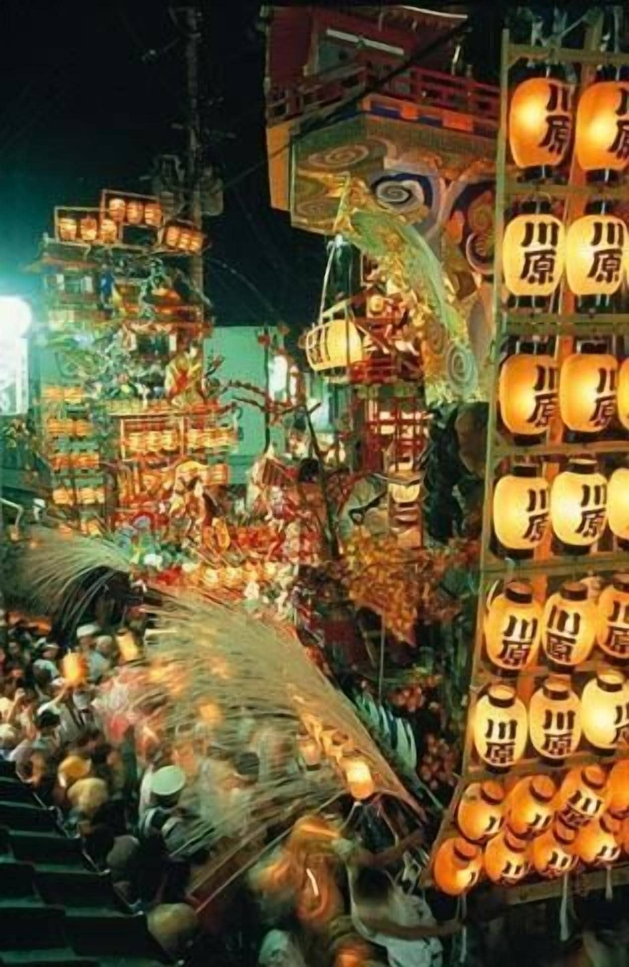 A crowded indoor market with various stalls and hanging lanterns.
