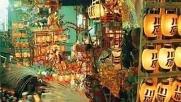 A crowded indoor market with various stalls and hanging lanterns.