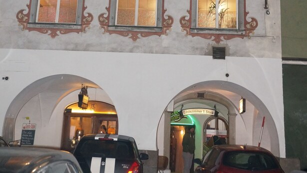 A historic building with ornate window frames and a central entrance with a sign. - Pension Aksaray (Feldkirch)