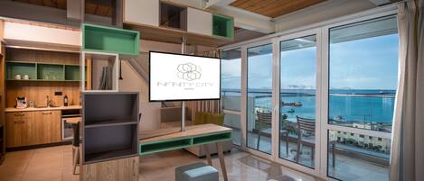 Deluxe Suite, Sea View (Junior) | Minibar, in-room safe, desk, soundproofing