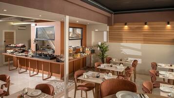 A modern dining area with a buffet, multiple tables, and chairs.