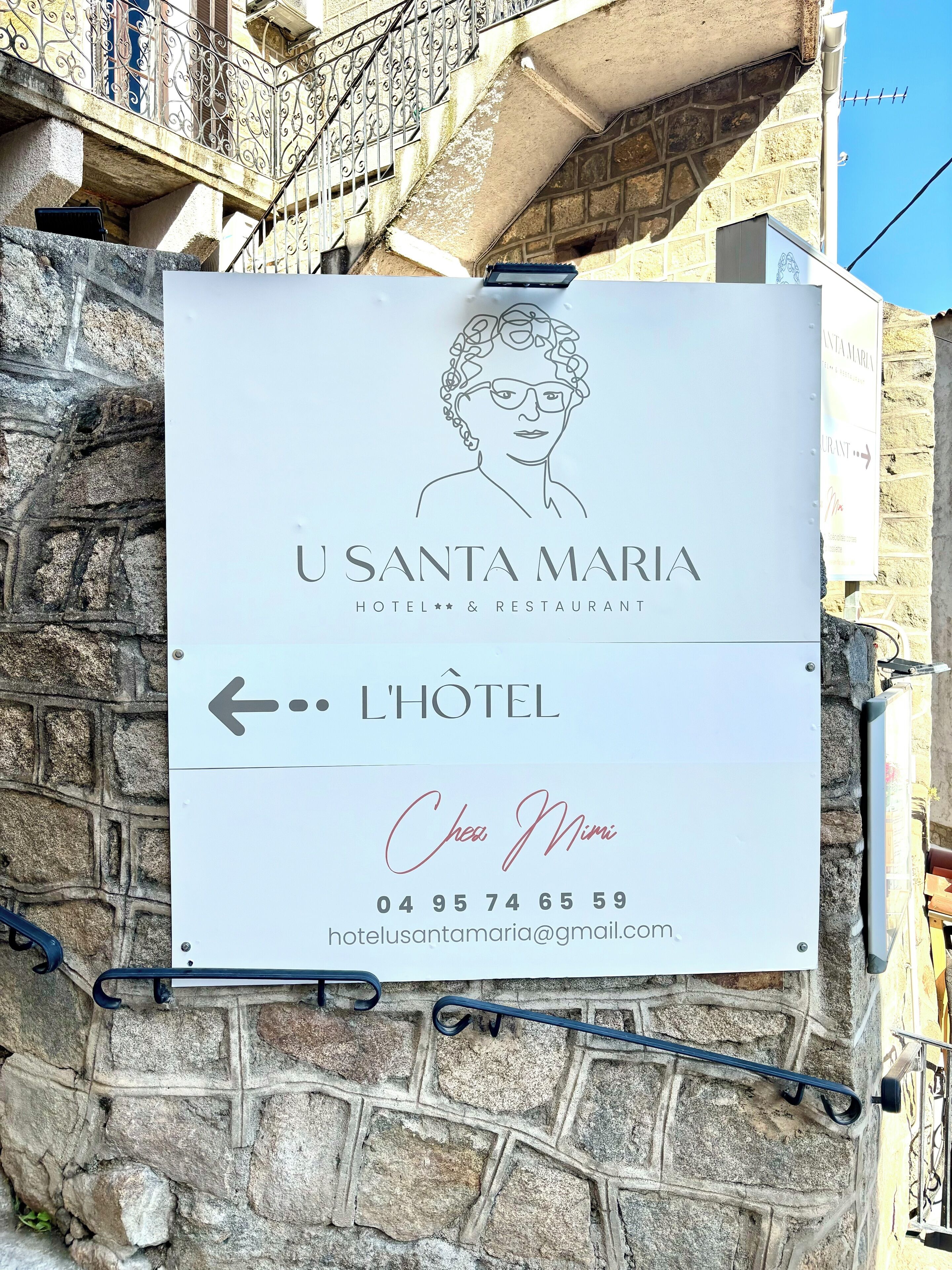 A sign for 'U SANTA MARIA HOTEL & RESTAURANT' with an arrow pointing left, indicating the direction to the hotel.