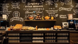 A breakfast buffet with various food items and a coffee machine.