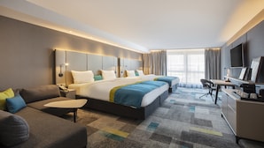 A hotel room with a large bed, a desk, a chair, and a television. - Holiday Inn Villingen - Schwenningen by IHG (Villingen-Schwenningen)