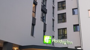 A Holiday Inn hotel with a modern facade, large windows, and a prominent green sign. - Holiday Inn Villingen - Schwenningen by IHG (Villingen-Schwenningen)