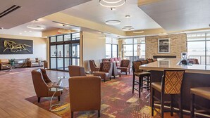 A spacious lobby with leather chairs, a bar area, and large windows offering views. - The Hotel at Sunland Park Casino El Paso, an Ascend Collection Hotel (Sunland Park)