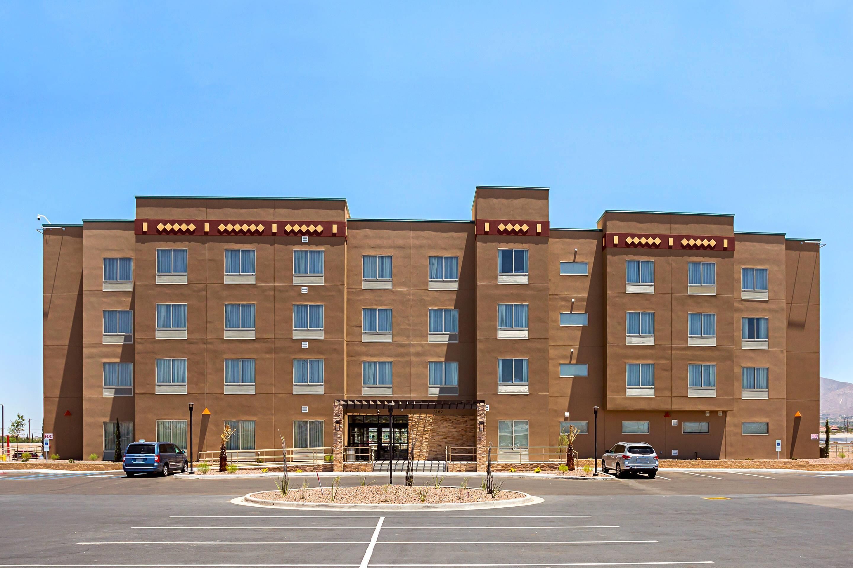 A multi-story hotel with a symmetrical facade, large windows, and a central entrance with a covered area.