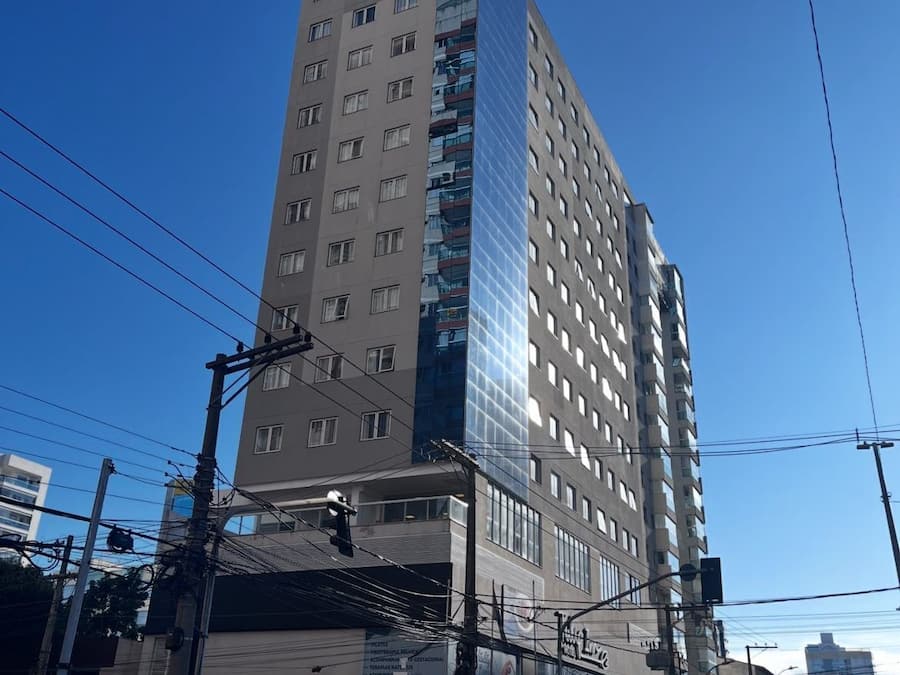 A tall hotel building with multiple floors and a modern glass facade.
