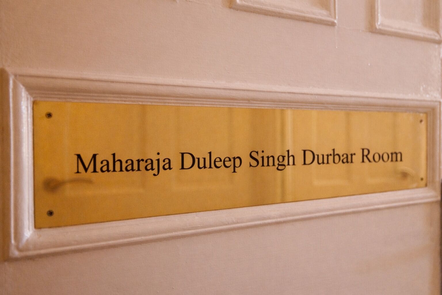 A sign with the text 'Maharaja Duleep Singh Durbar Room' on a yellow background.