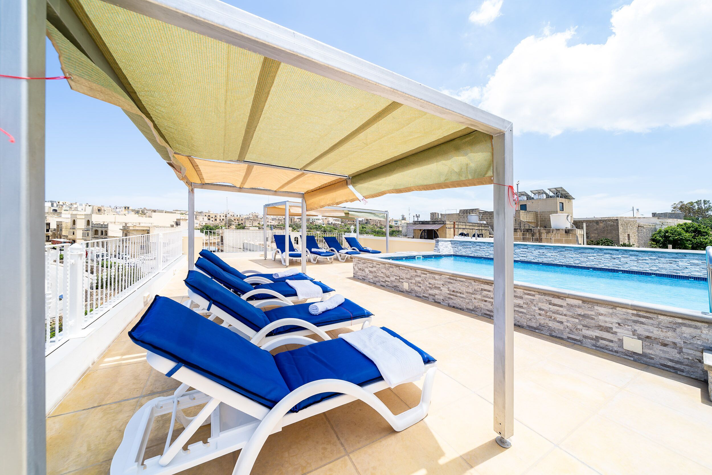 outdoor pool, open 7:00 am to 8:00 pm, pool umbrellas, pool loungers