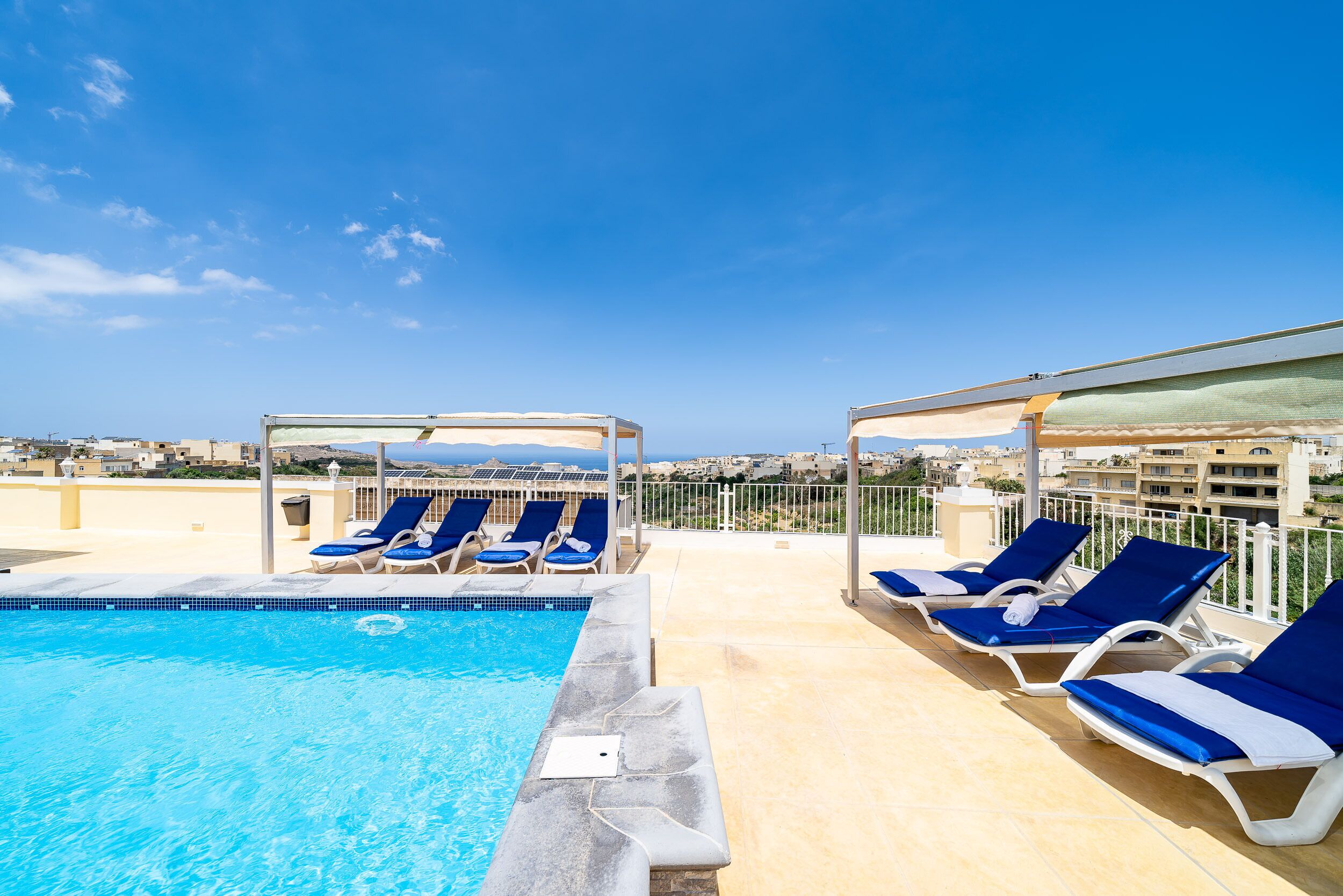 outdoor pool, open 7:00 am to 8:00 pm, pool umbrellas, pool loungers