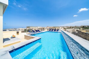 Relax by the rooftop pool with a stunning city view.