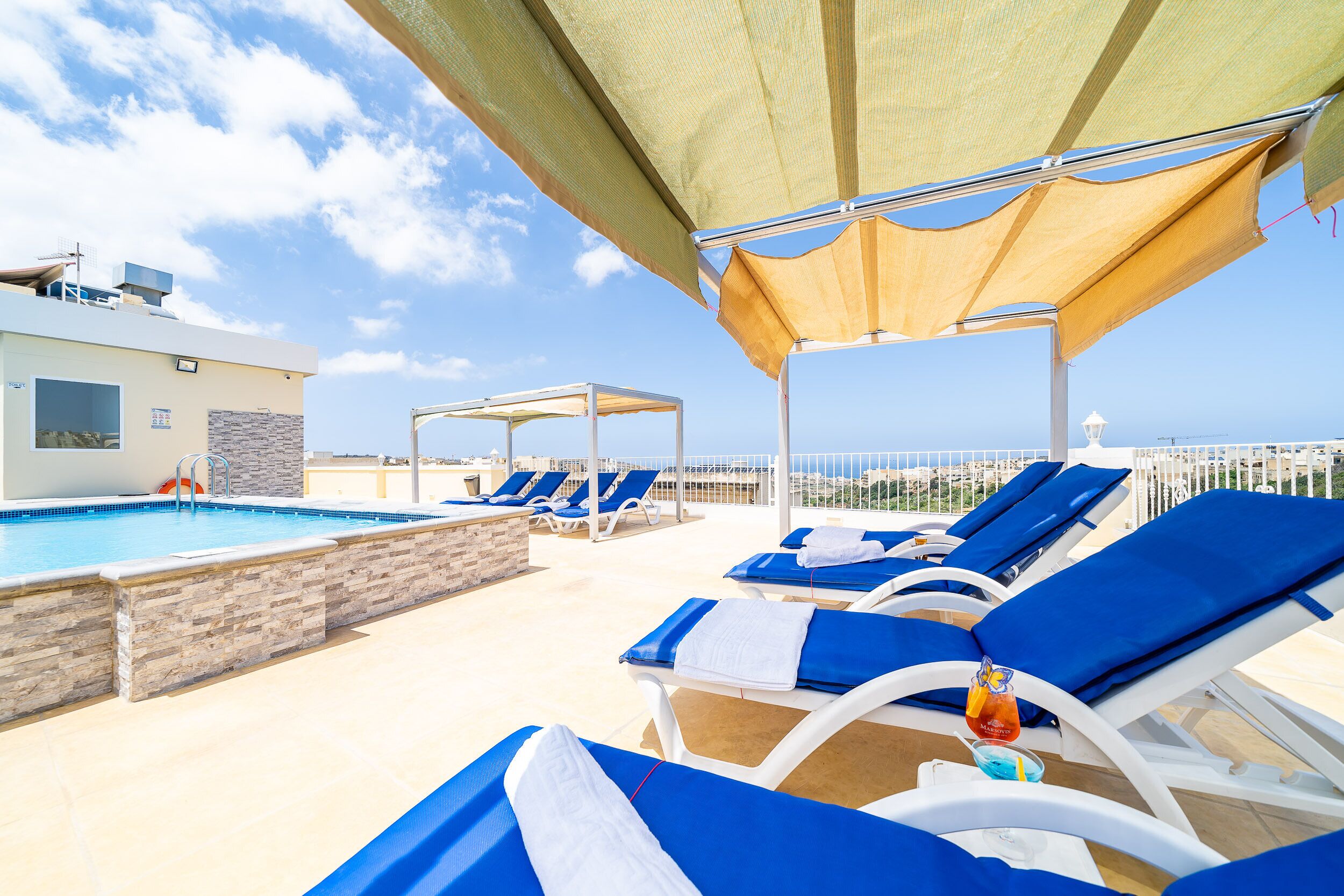 outdoor pool, open 7:00 am to 8:00 pm, pool umbrellas, pool loungers