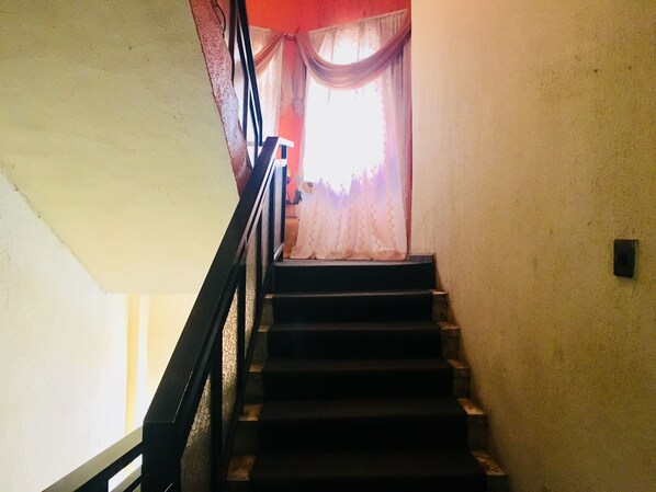 Una escalera con barandilla negra que lleva a una plataforma.