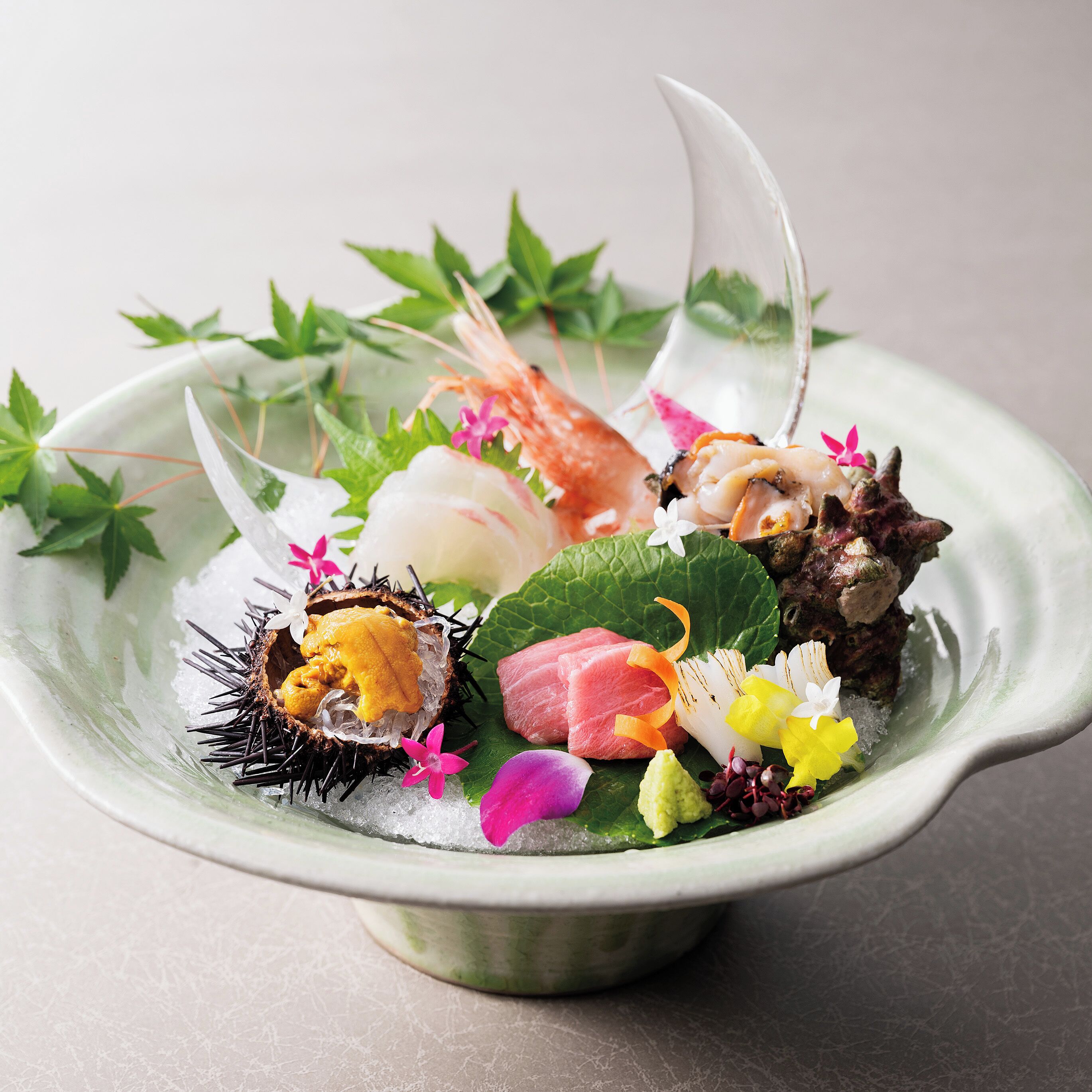 A bowl of sushi with various ingredients and garnishes.