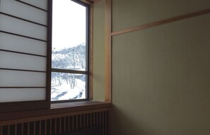 A room with a window overlooking a snowy landscape. - Hakuba Landmark Happo Lodge (Hakuba)
