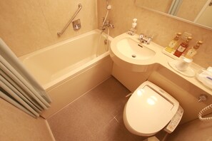 A bathroom with a bathtub, sink, and toilet.