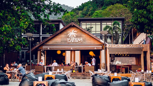 A beachside restaurant with outdoor seating and a sign reading "15 Palms". - 15 Palms Beach Resort (Ko Chang)