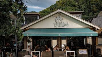 A restaurant named '15 Palms' with outdoor seating and a tropical theme.