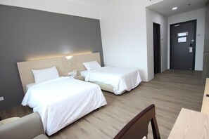 A hotel room with two beds, a wooden floor, and a desk with a chair. - Summit Signature Hotel Batu Pahat (Batu Pahat)