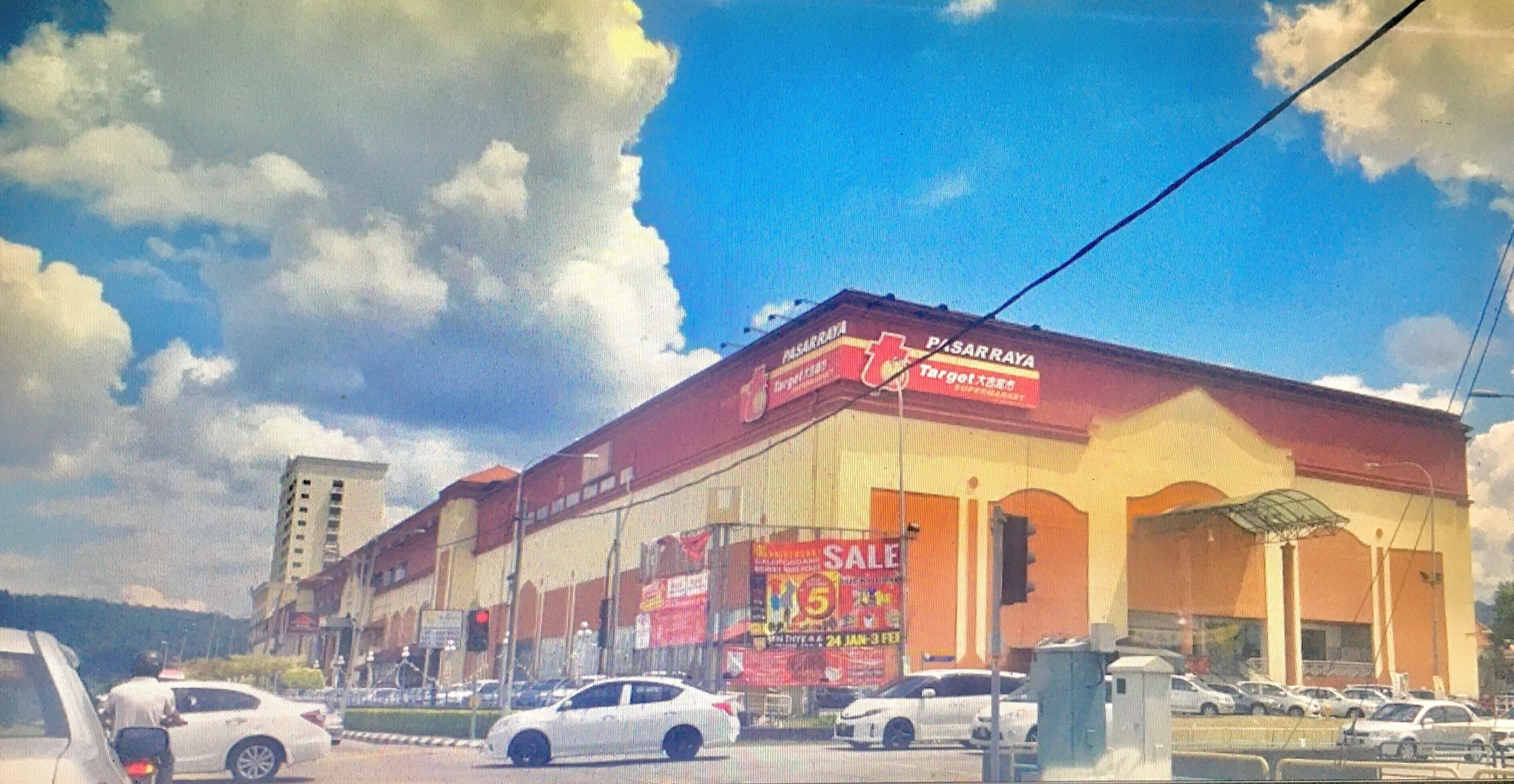 A shopping mall with a large sign advertising a sale.