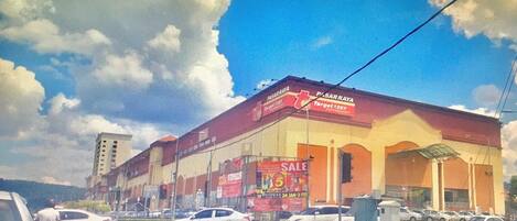 A shopping mall with a large sign advertising a sale.