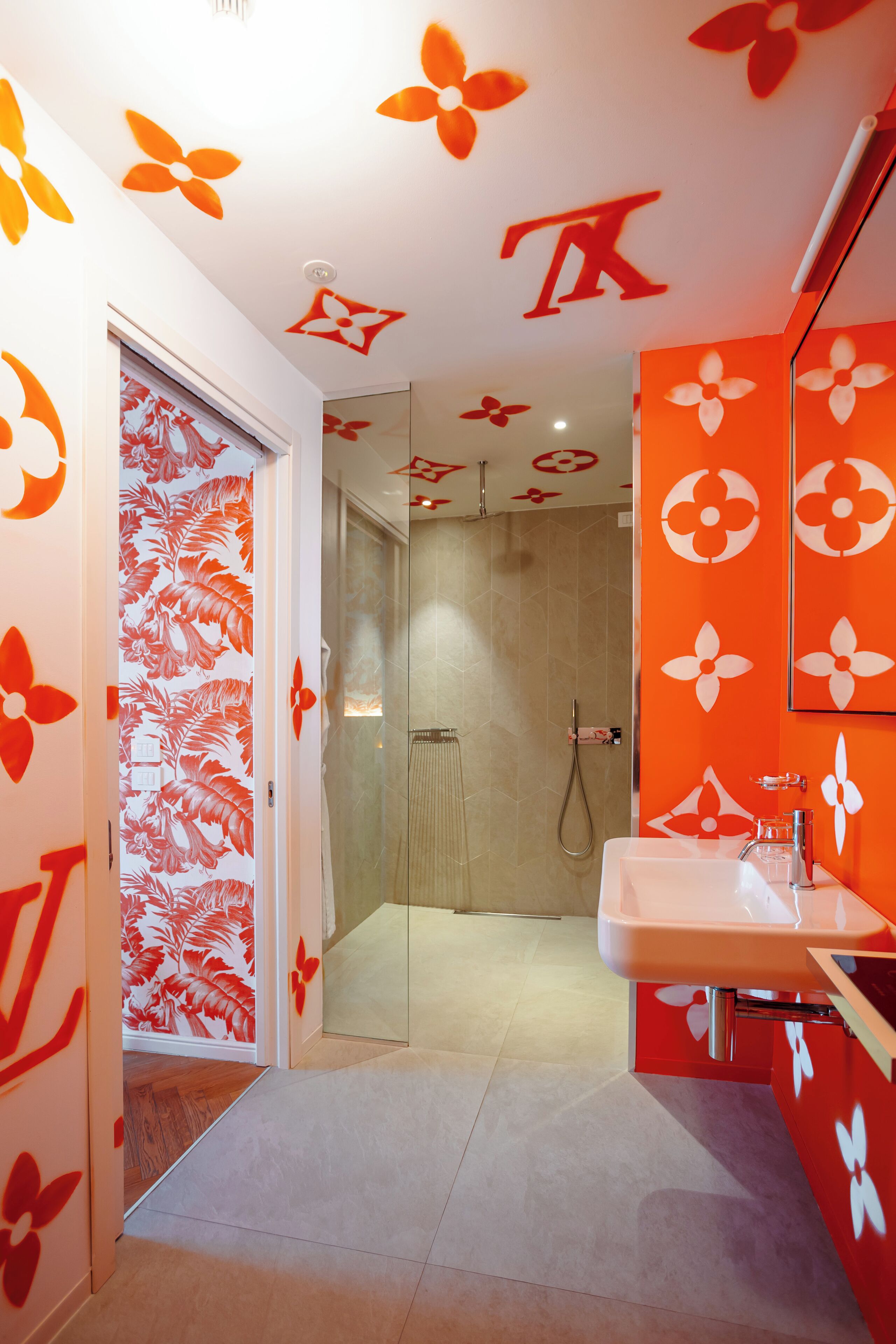 A modern bathroom with a shower, a sink, and a mirror.