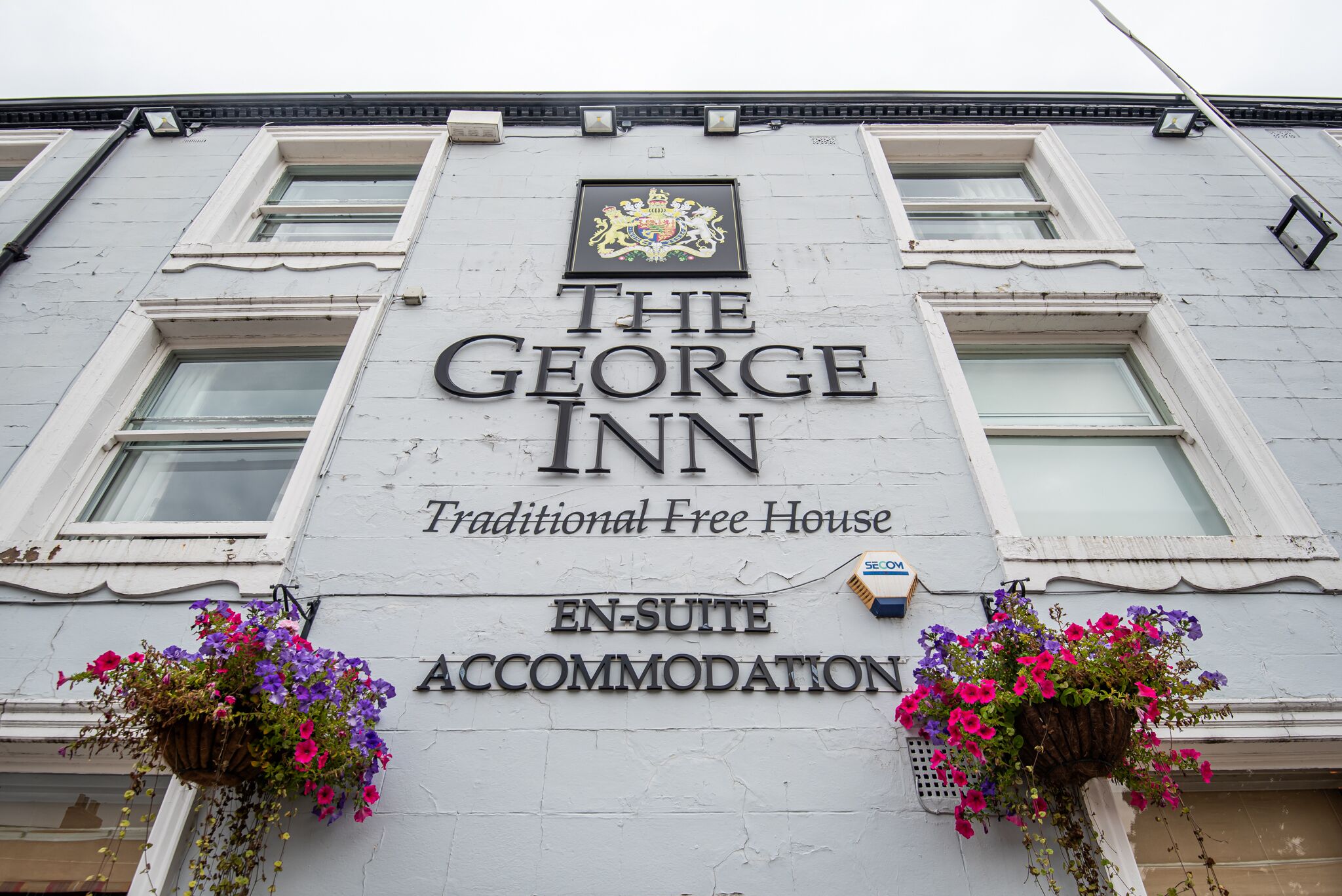 A building with 'The George Inn' signage, indicating it's a traditional free house.